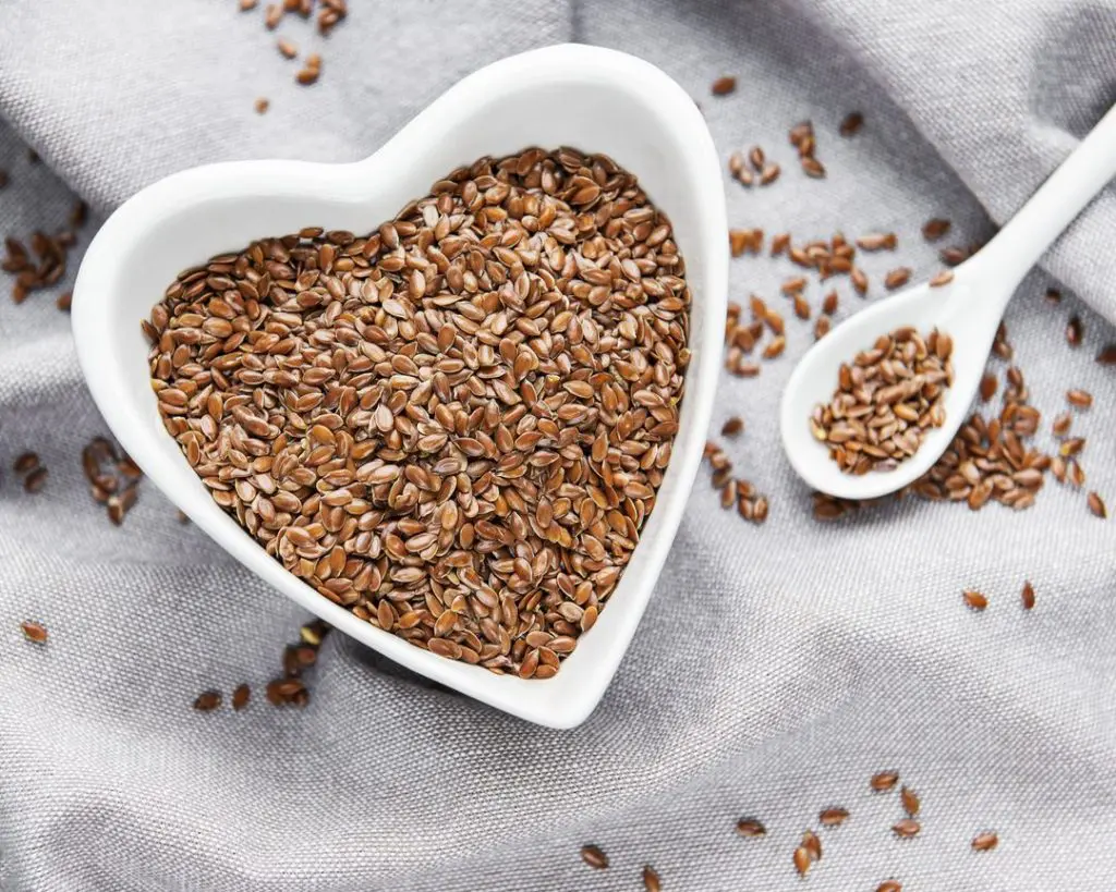 a heart shaped bowl full of seeds