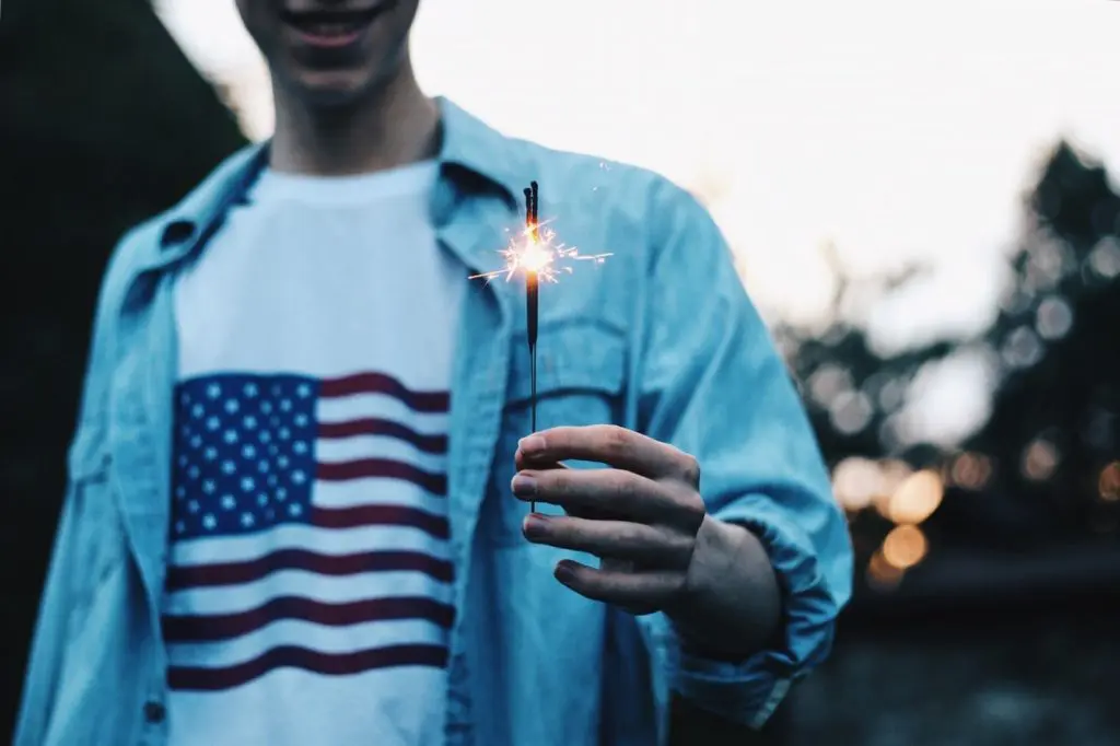 A young man with a sparkler enjoying a sober 4th of July
