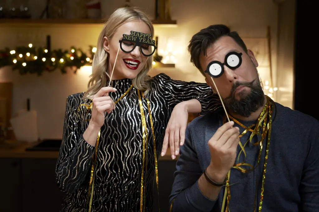 a couple taking fun photos as part of a sober New Year's Eve