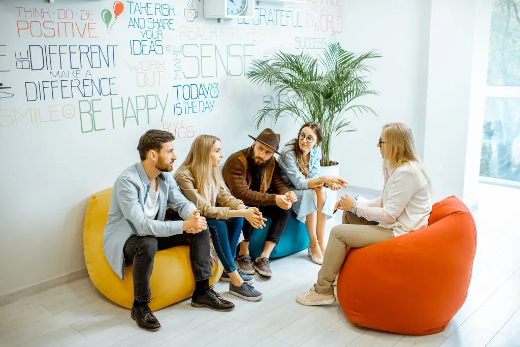 people sitting with a counselor utilizing addiction intervention strategies