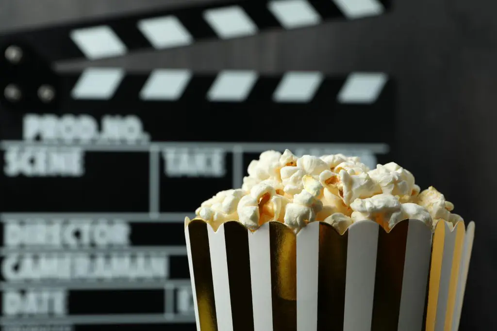 A bucket of popcorn and a slate in the background representing the best addiction movies