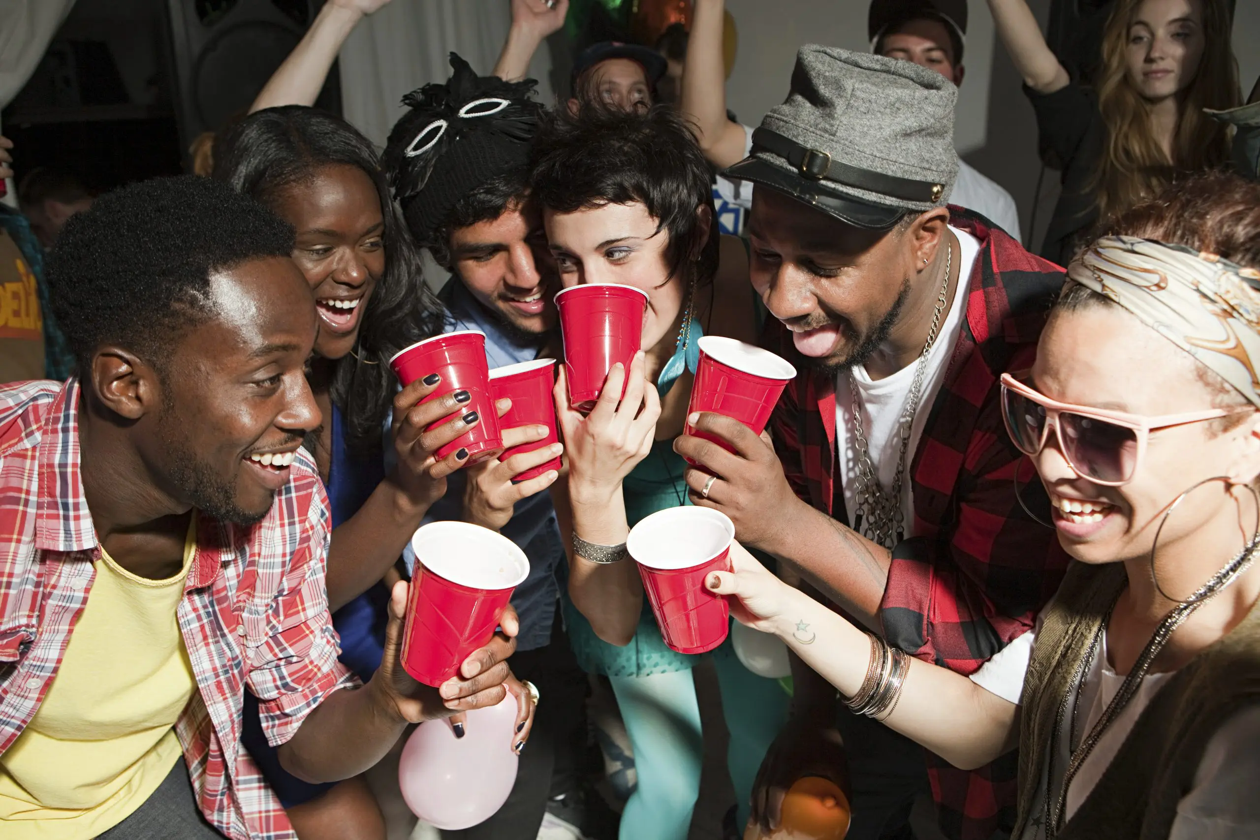 people social drinking with red cups and a toast