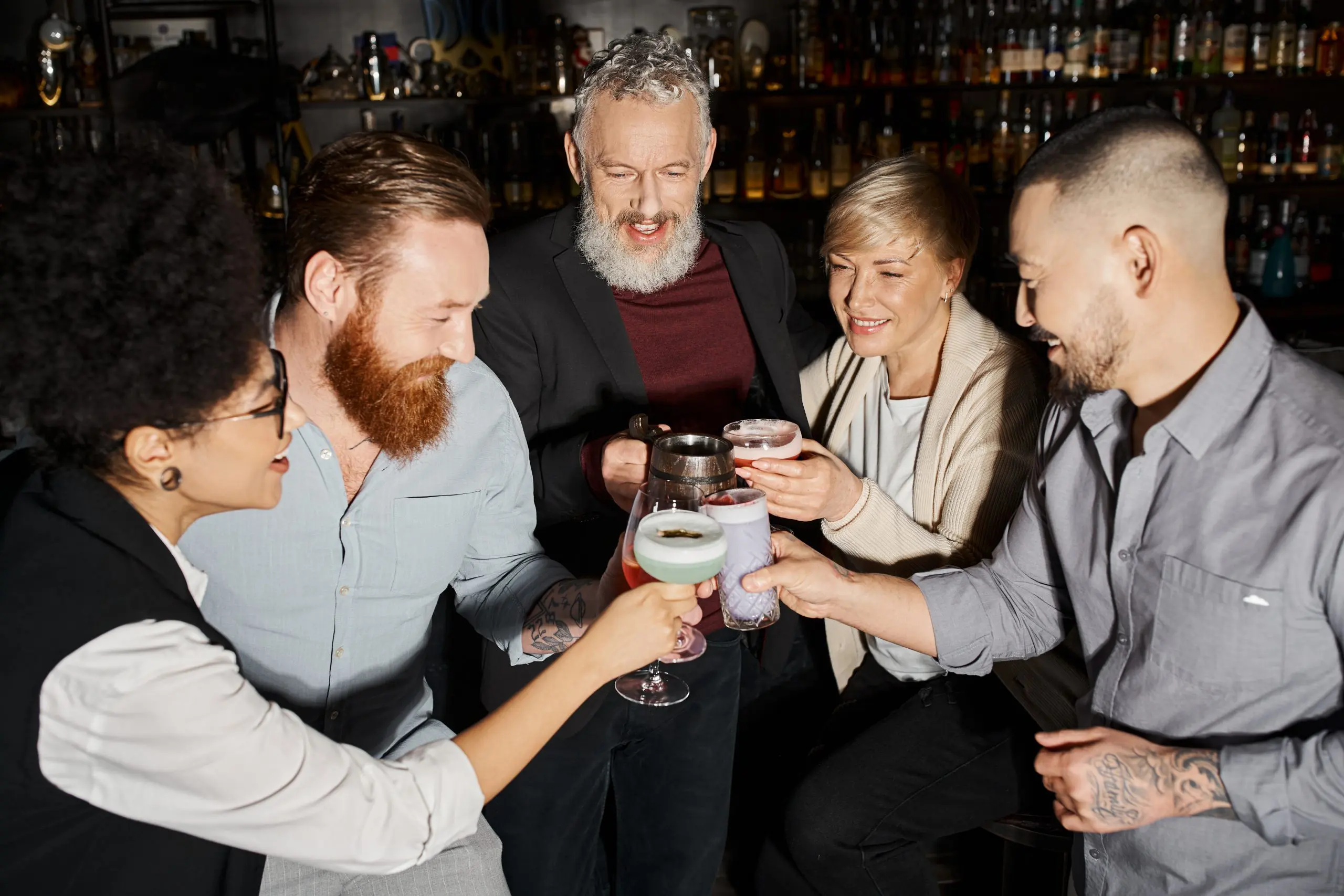 a group of people drinking in a cocktail lounge begging the question "why is alcohol socially accepted"