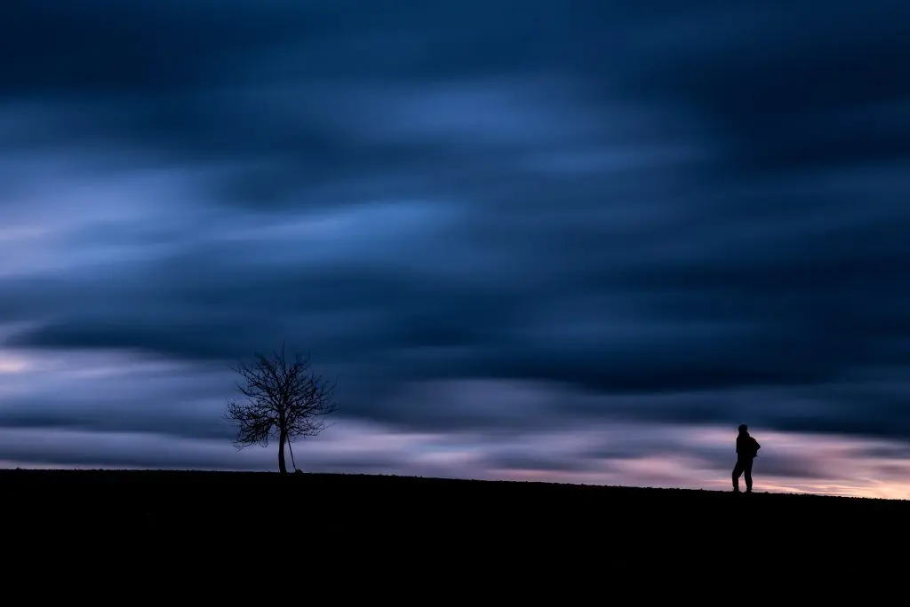 a man standing alone at night to represent the horrors of ghb and alcohol overdose
