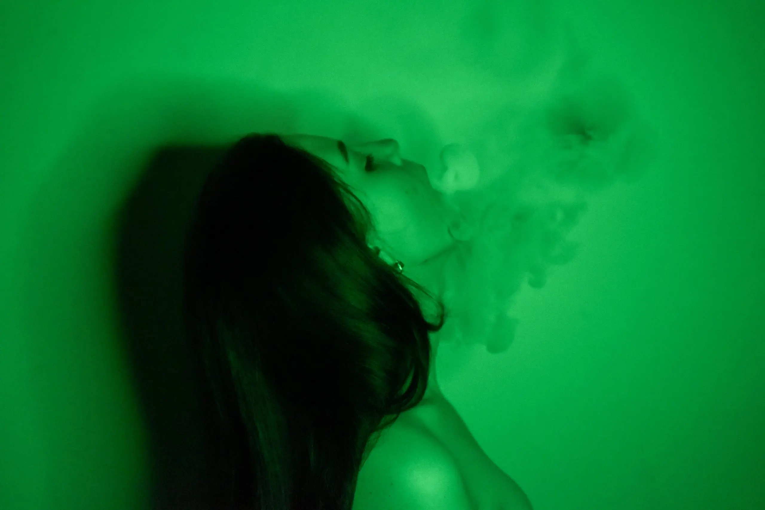 a woman smoking, begging the question "how long does DMT last"?