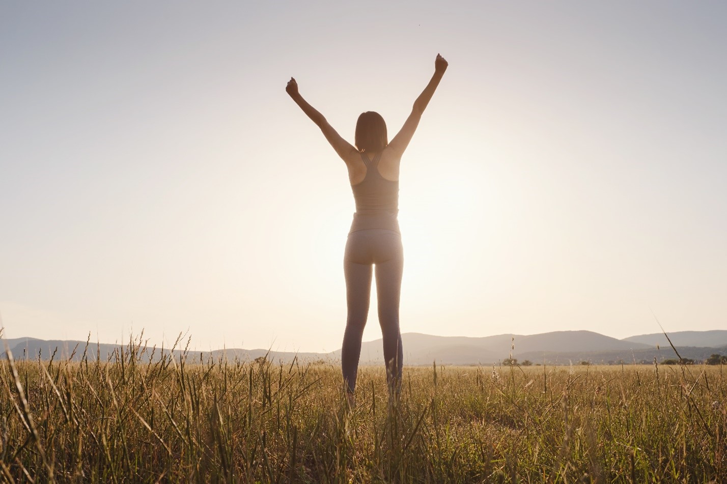 a woman celebrating addiction recovery after inpatient detox