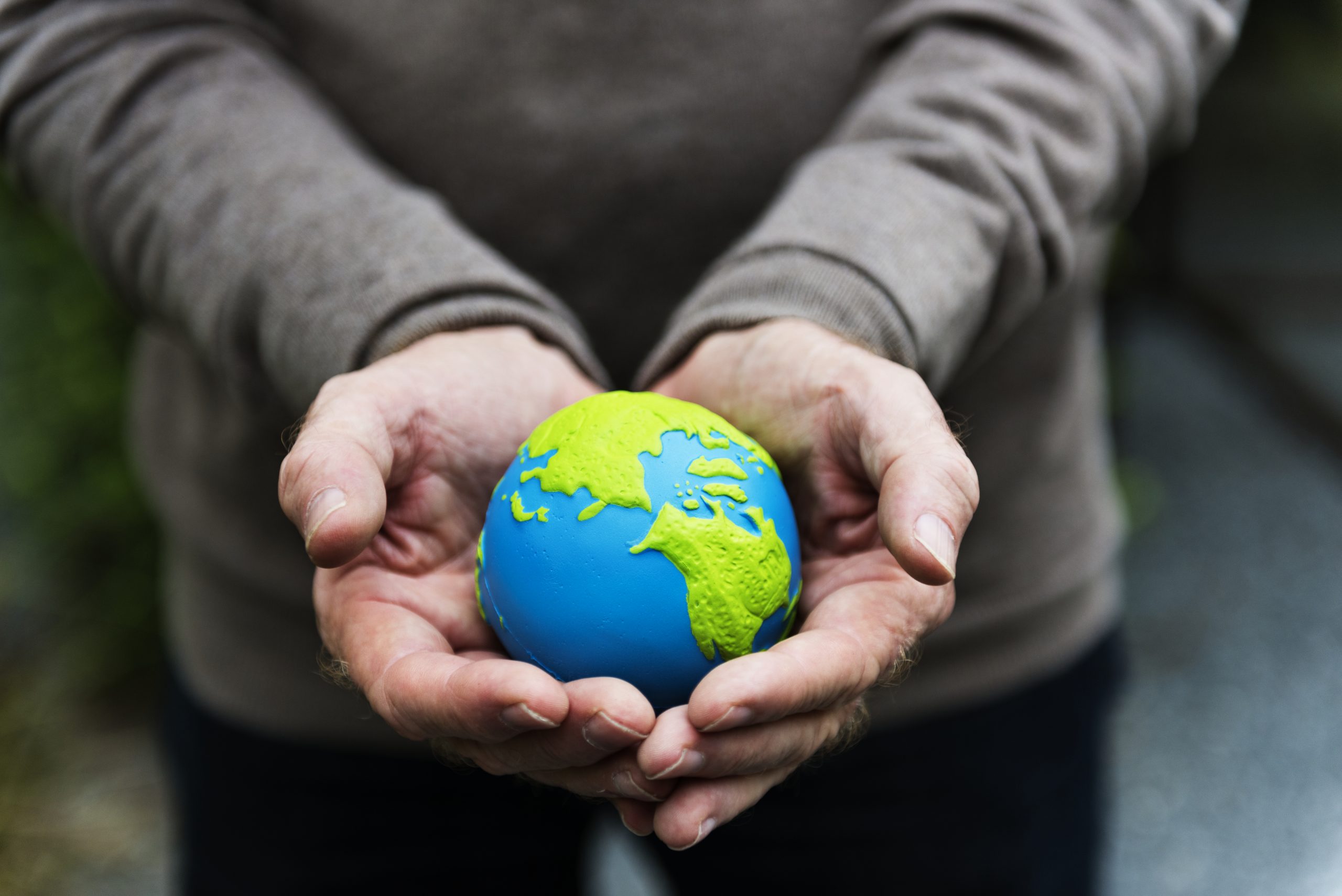 holding a clay globe of Earth, representing International Overdose Awareness Day
