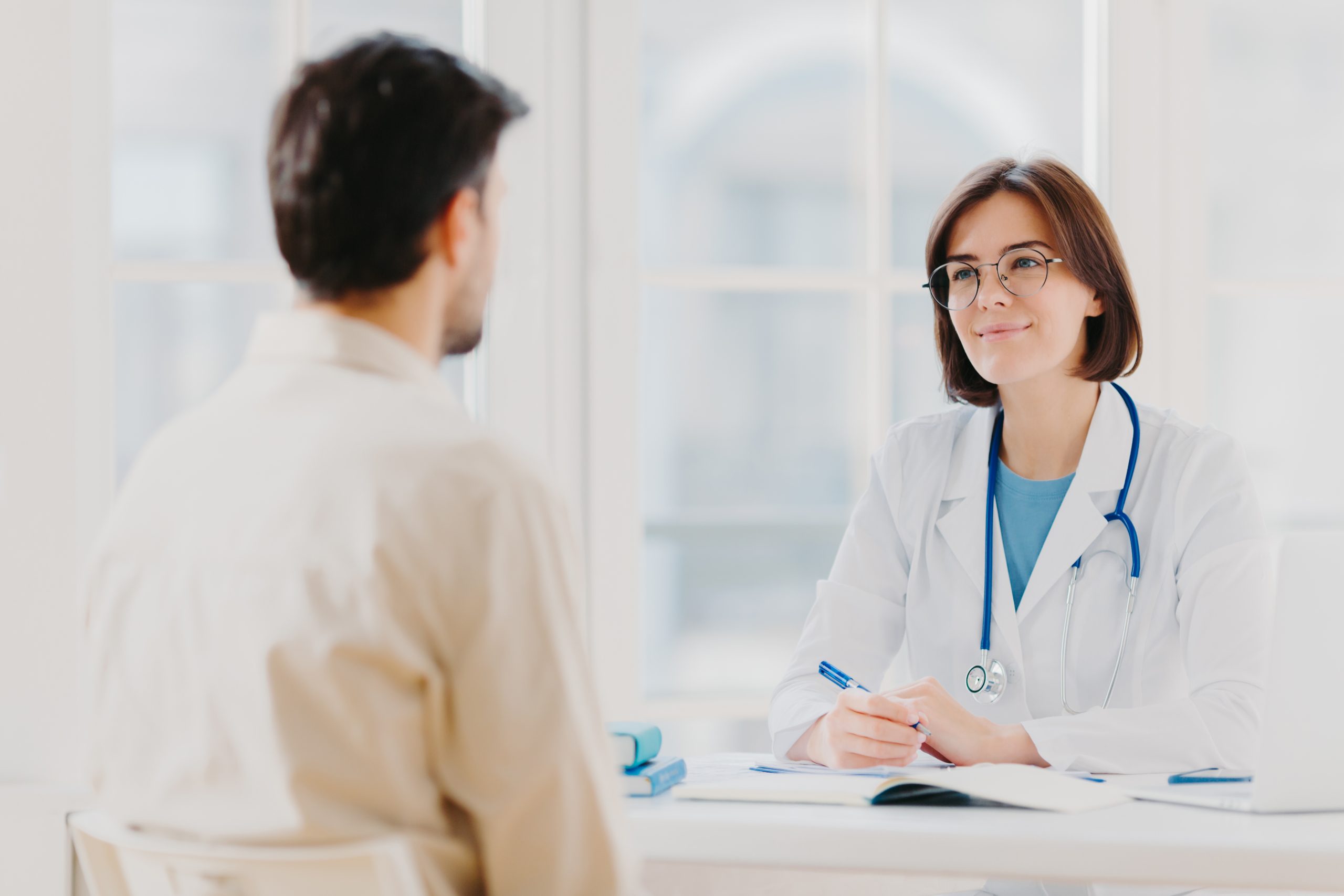 a patient talking to a doctor trying to decide between detox vs rehab