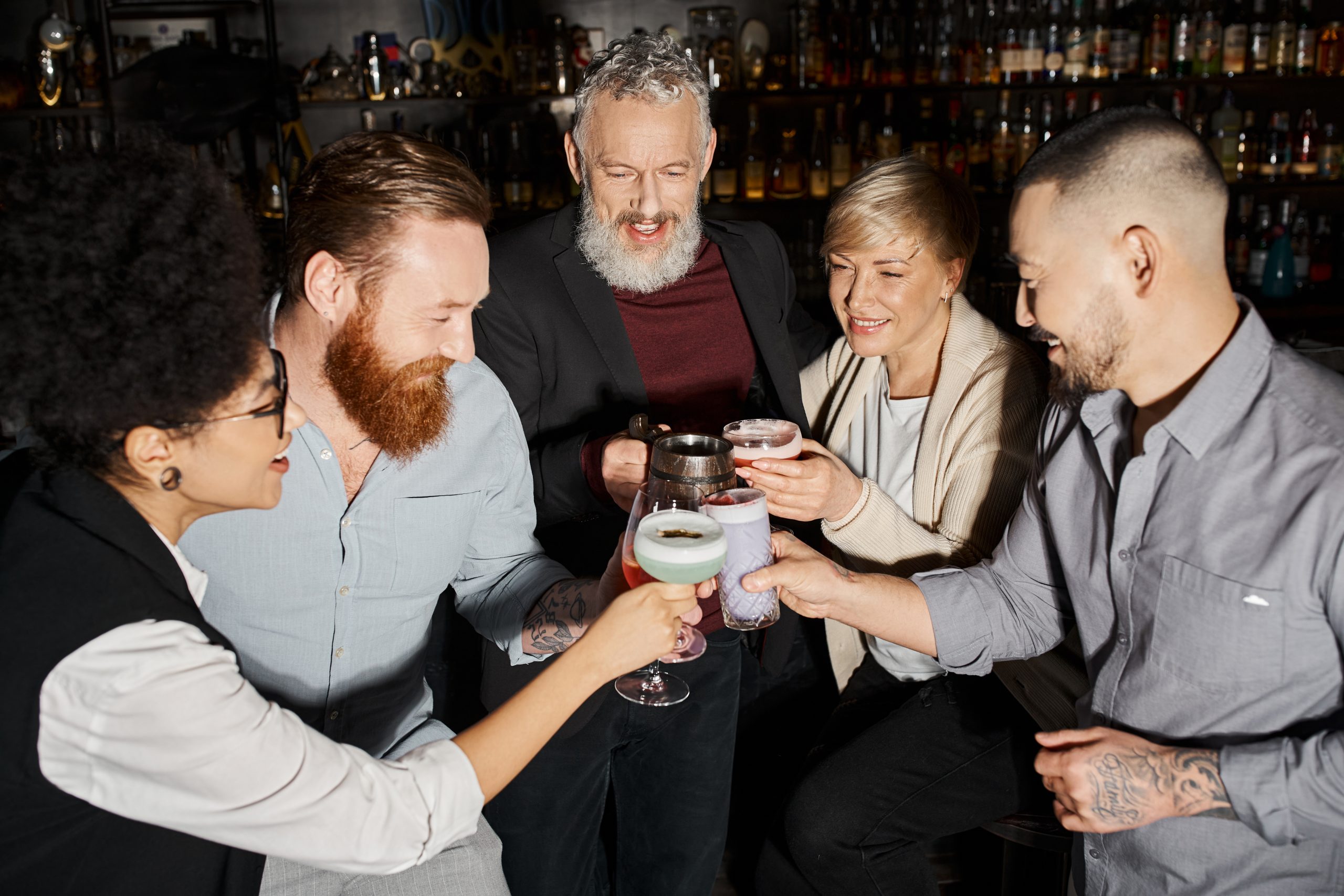 a group of people drinking in a cocktail lounge begging the question "why is alcohol socially accepted"