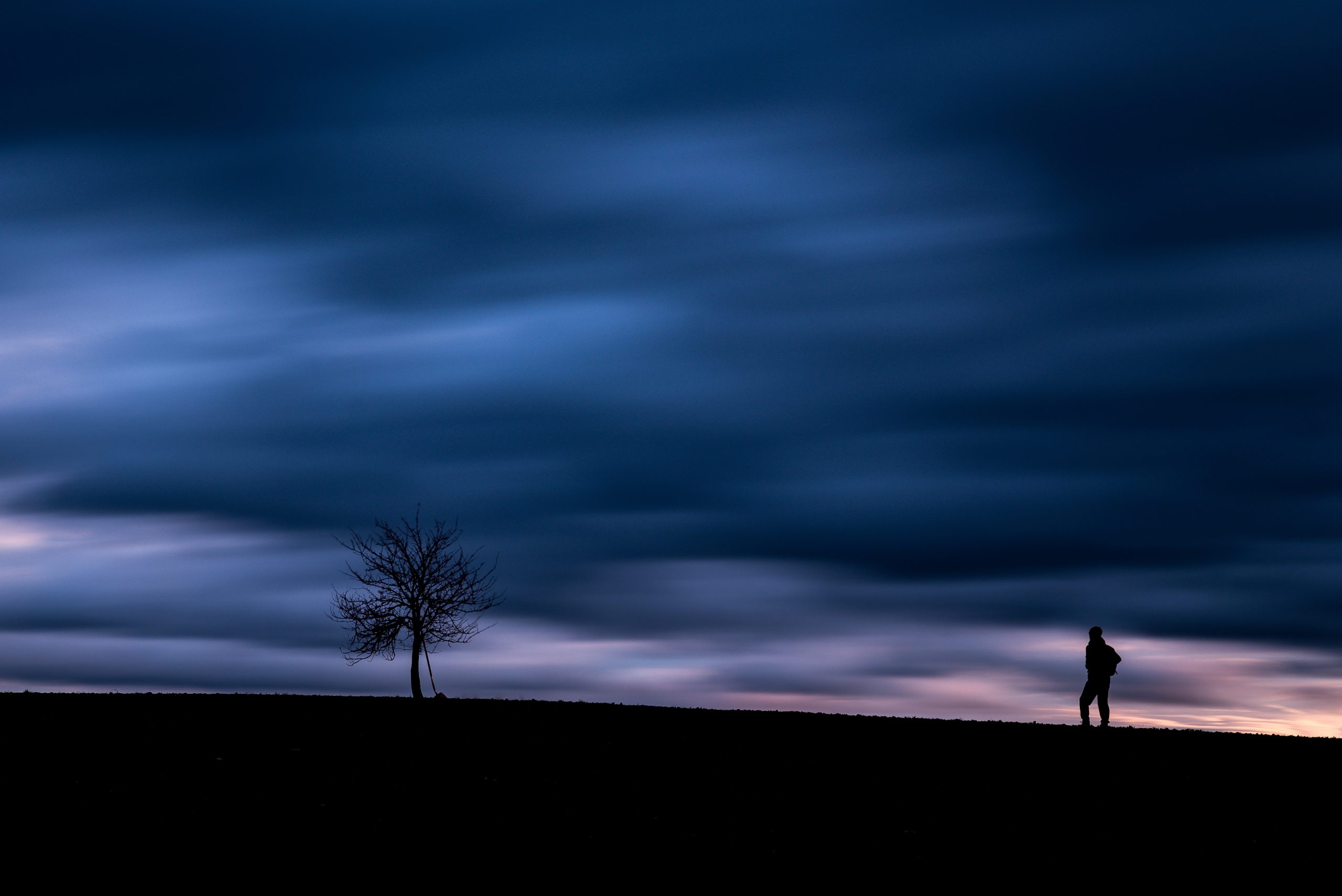 a man standing alone at night to represent the horrors of ghb and alcohol overdose