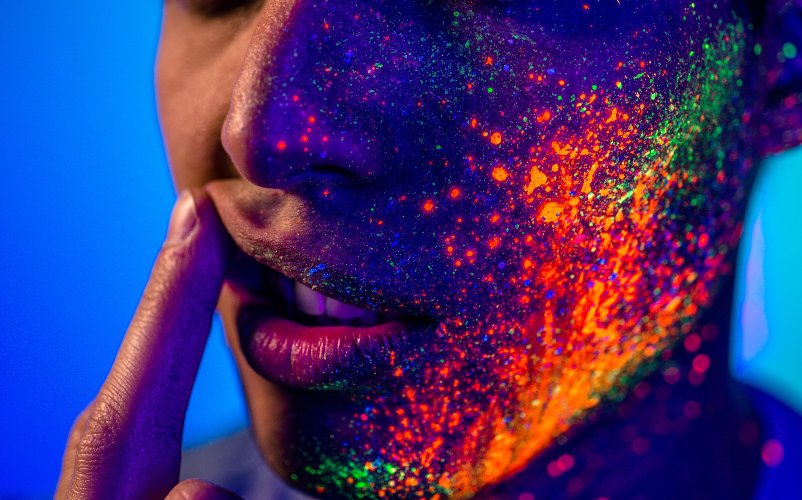 a woman's face covered with paint implying the withdrawal symptoms of acid