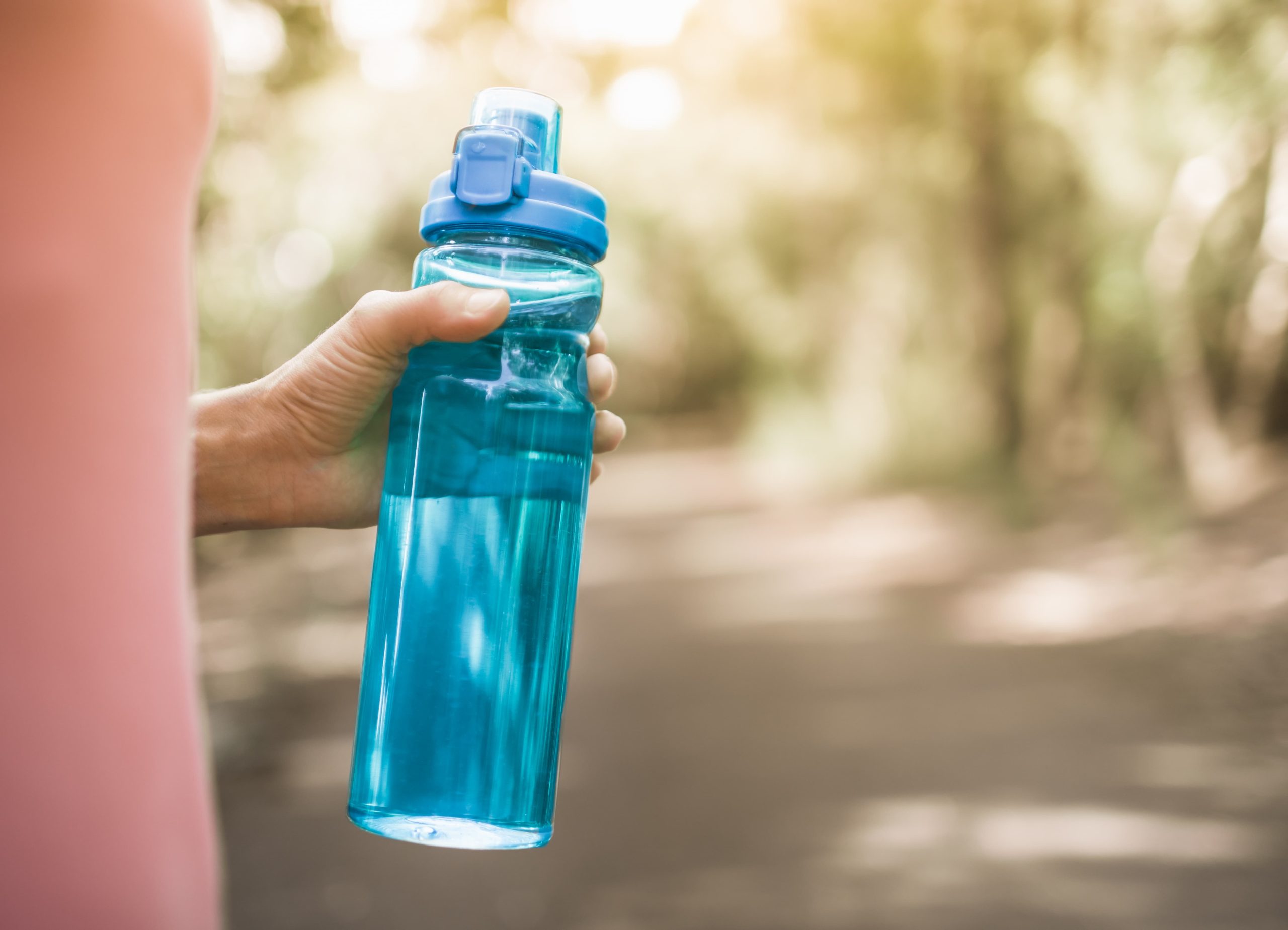 Staying hydrated in early sobriety with a refillable water bottle during daily routine